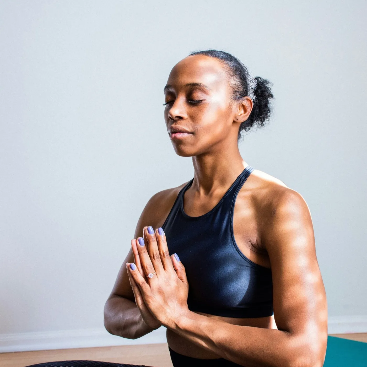 A woman with her eyes closed in a calm, meditative pose